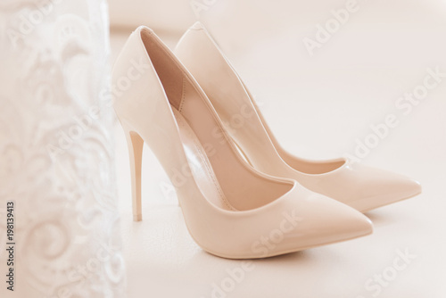 Womens wedding shoes on svetlom the background, the fees of the bride, selective focus