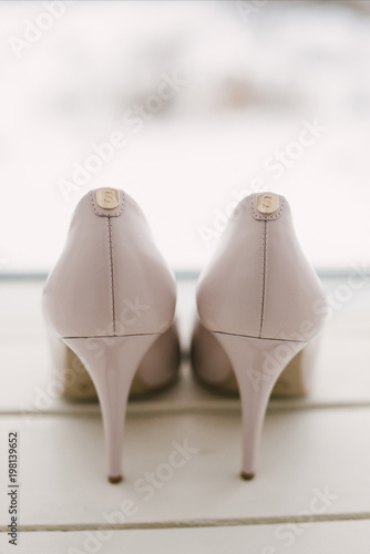 Womens wedding shoes on svetlom the background, the fees of the bride, selective focus photo