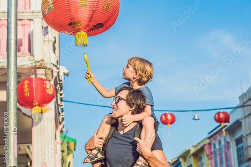 Dad and son are tourists on the Street in the Portugese style Romani in Phuket Town. Also called Chinatown or the old town