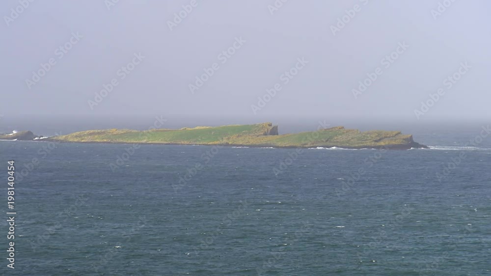 A steady scenic shot of a small island in Ireland. A steady scenic shot of a small island in Ireland.