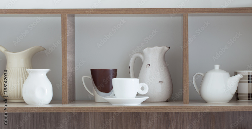 white kitchenware on wooden shelf