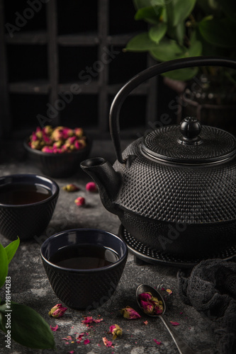 tea set. Cast iron eastern tea pot, cups and dry rose