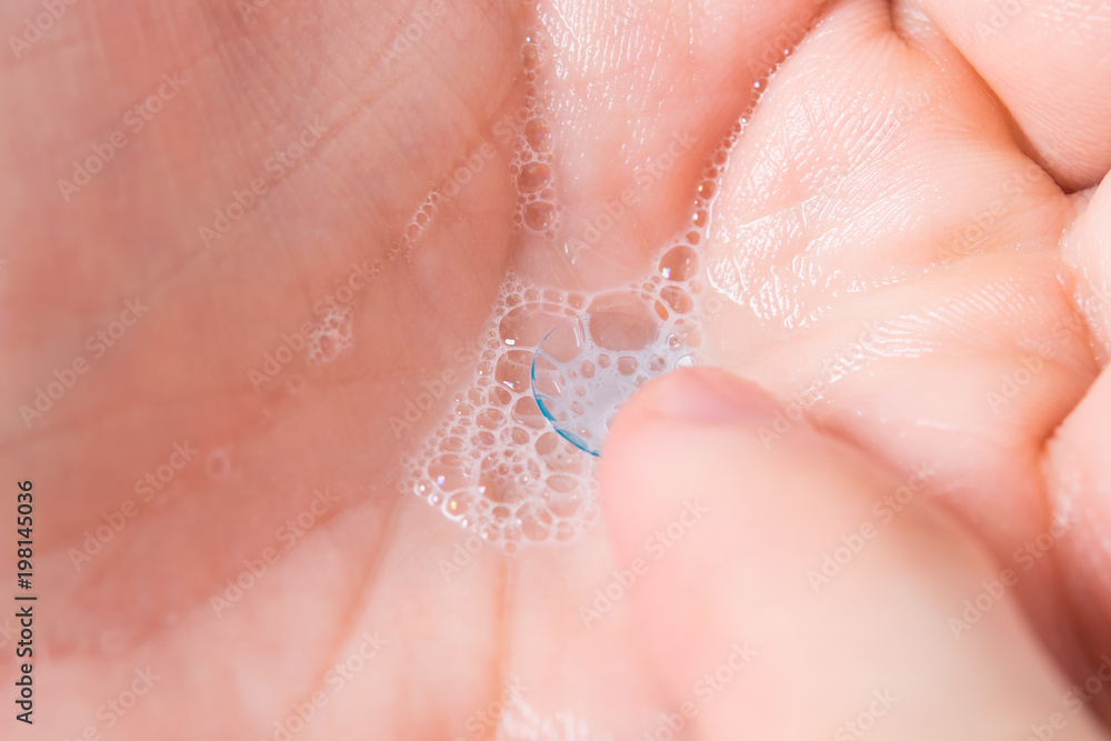 Fototapeta premium contact lens to improve vision, in the palm of your hand