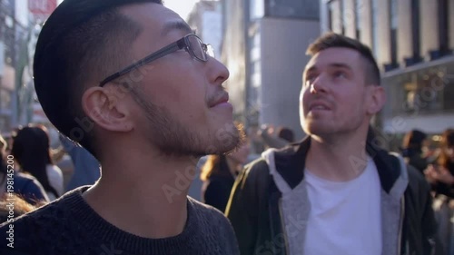 International friends exploring bustling Japanese city centre. photo