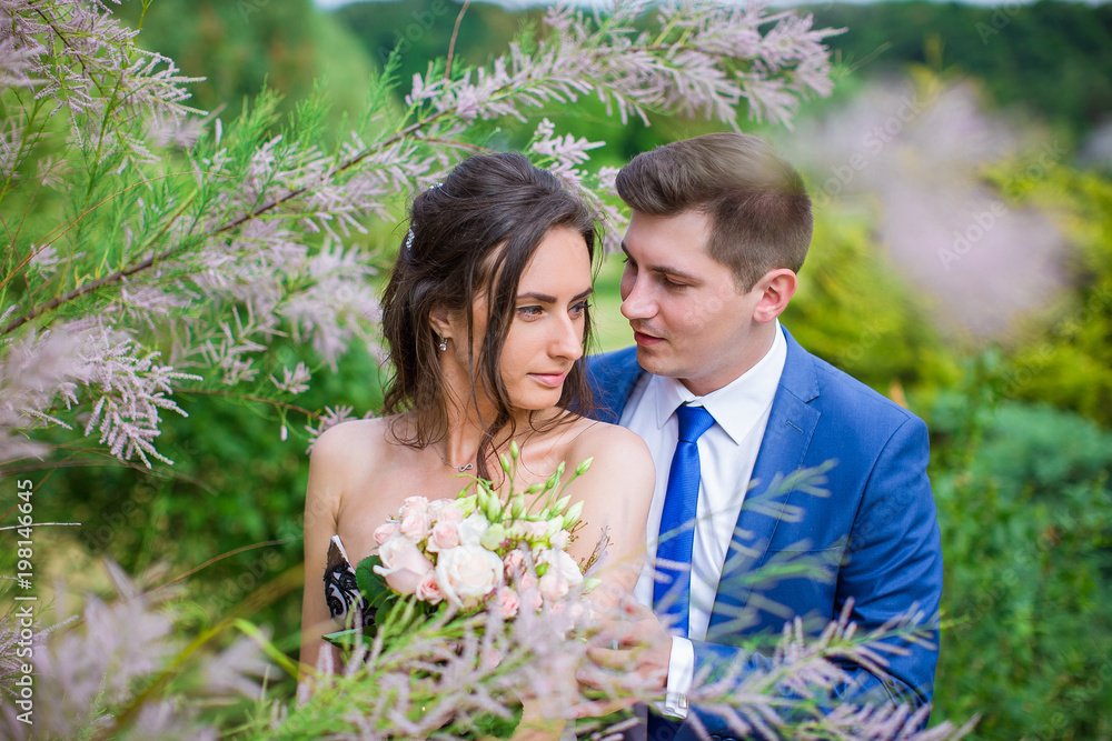 Portrait of newlywed couple in park