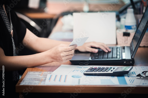 Business woman hands holding credit card and using laptop for online shopping. Online shopping concept.