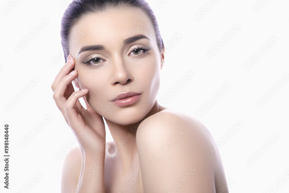 Close up of a beautiful brunette caucasian woman with fresh clean natural skin and soft smile on her face. Neutral, daily make up