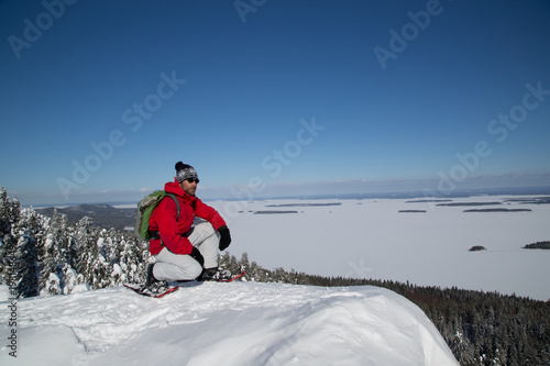 Snowshoe hiker on the Paha-Koli peak enjoys the winter landscape