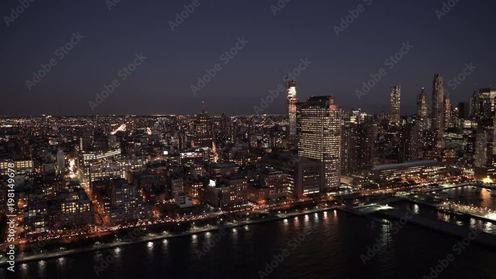 New York City aerial view approaching Lower Manhattan Financial District at night, from the Hudson River New York City aerial view approaching Lower Manhattan Financial District at night, from the Hudson River