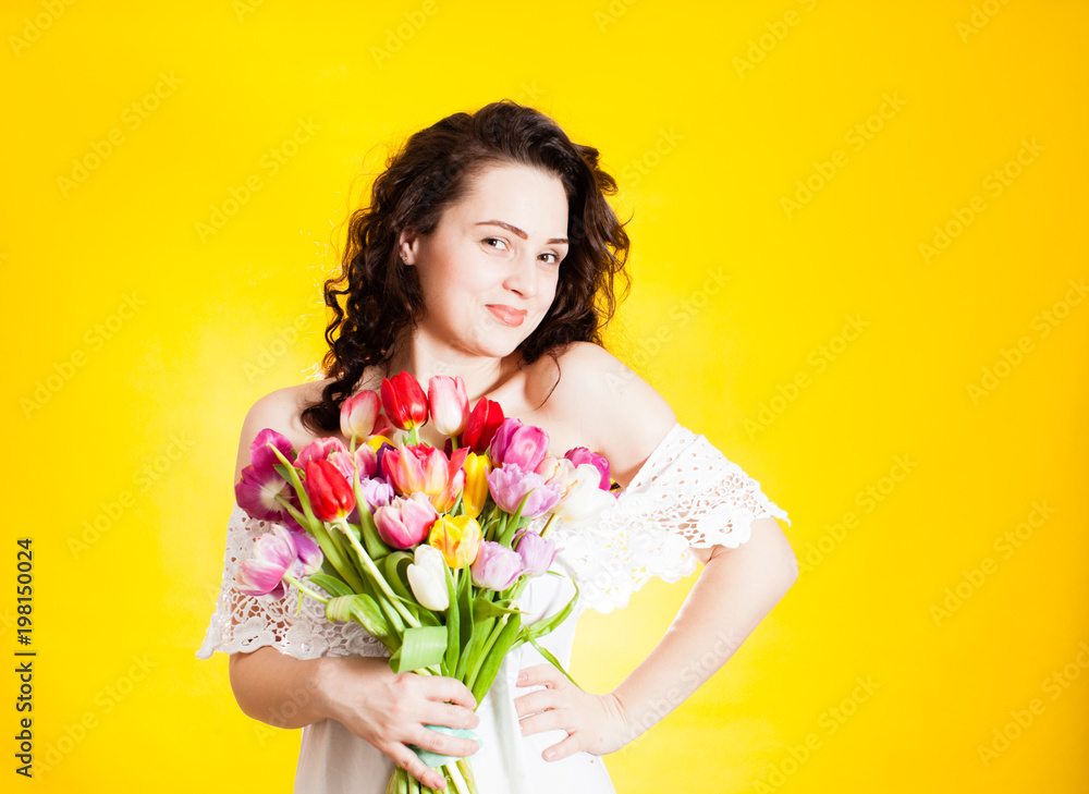 Beautiful woman with tulips in hand