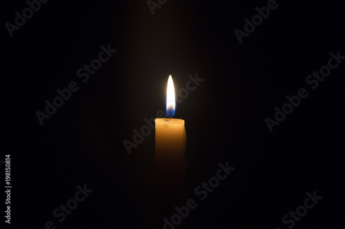 Candle flame closeup isolated on black. Abstract Background.