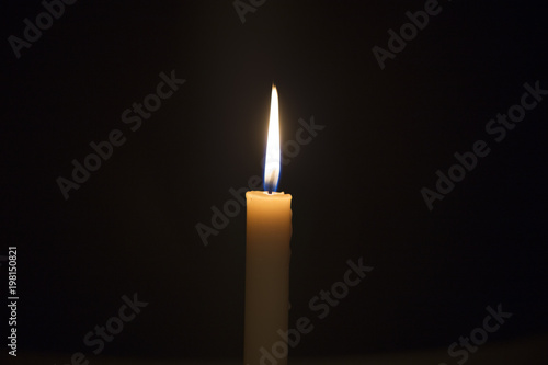 Candle flame closeup isolated on black. Abstract Background.