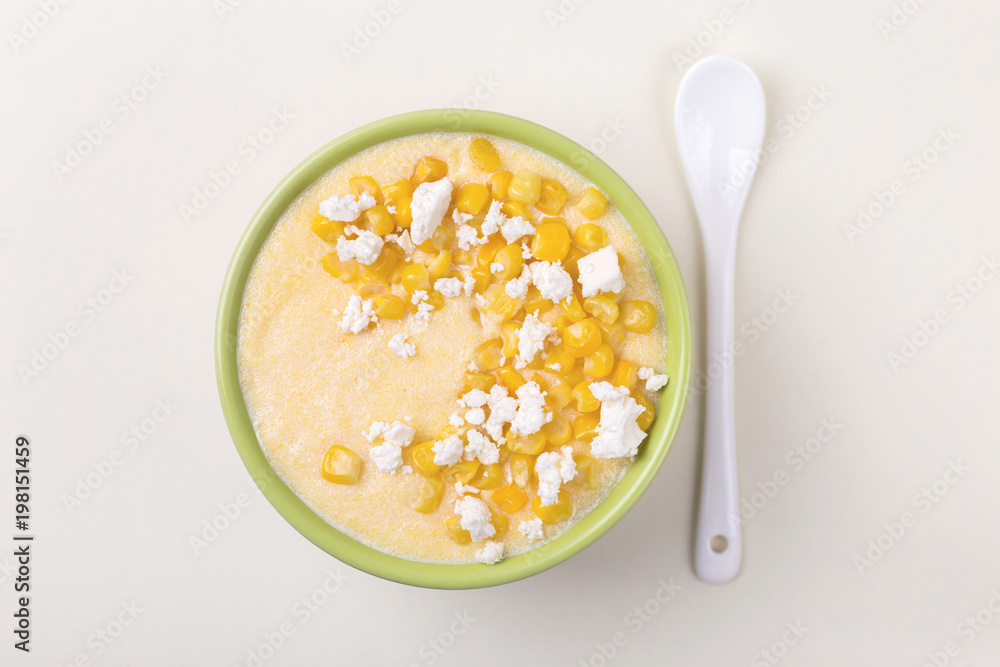 Polenta with feta. Corn porridge. Italian appetizers. Wooden background. Polenta with feta. Corn porridge. Italian appetizers. Wooden background.