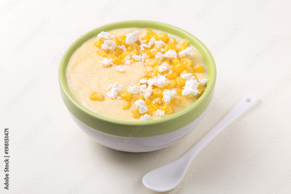 Polenta with feta. Corn porridge. Italian appetizers. Wooden background. Polenta with feta. Corn porridge. Italian appetizers. Wooden background.