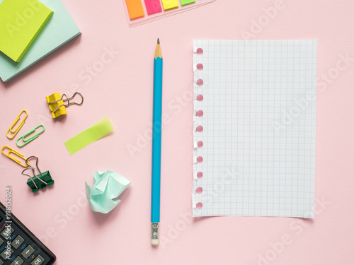 Business flat lay with copy space on a background pink Notebooks to write text stickers Pencil, Stationery color paper clip, calculator