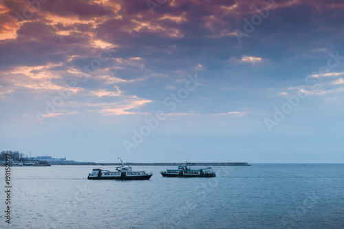 Passenger ships under colorful evening sky