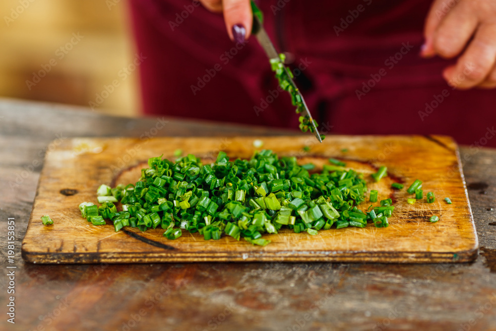 chopped green onion on wooden board chopped green onion on wooden board