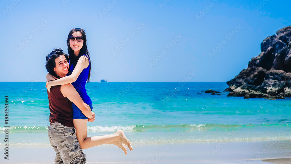 couple love on the beach.a man carrying a woman near the sea on vacation.tourist enjoying on holiday couple love on the beach.a man carrying a woman near the sea on vacation.tourist enjoying on holiday