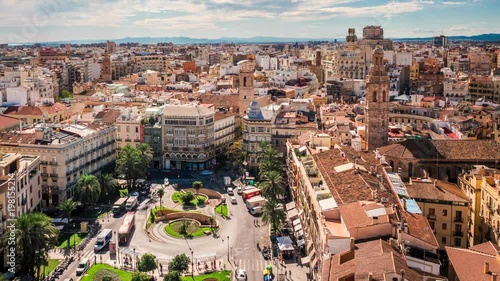 Valencia, Spain, time lapse view of traffic and people at Plaza de la Reina during daytime. Dolly right to left.  photo