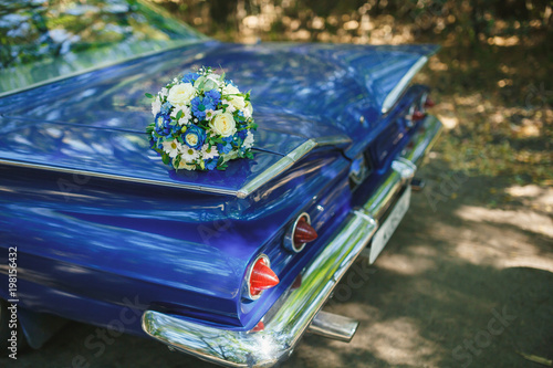 Wedding bouquet on vintage wedding car