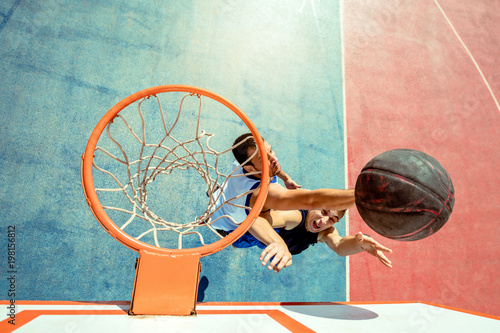 High angle view of basketball player dunking basketball in hoop