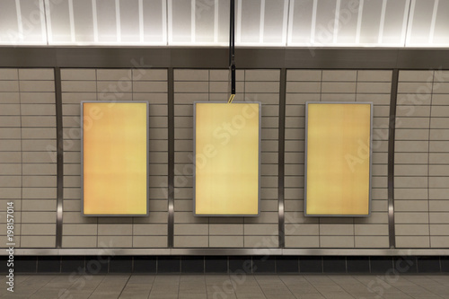 three big vertical poster on metro station