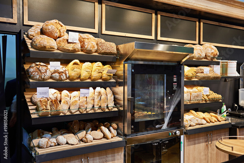 Fresh bread and pastries on shelves in bakery