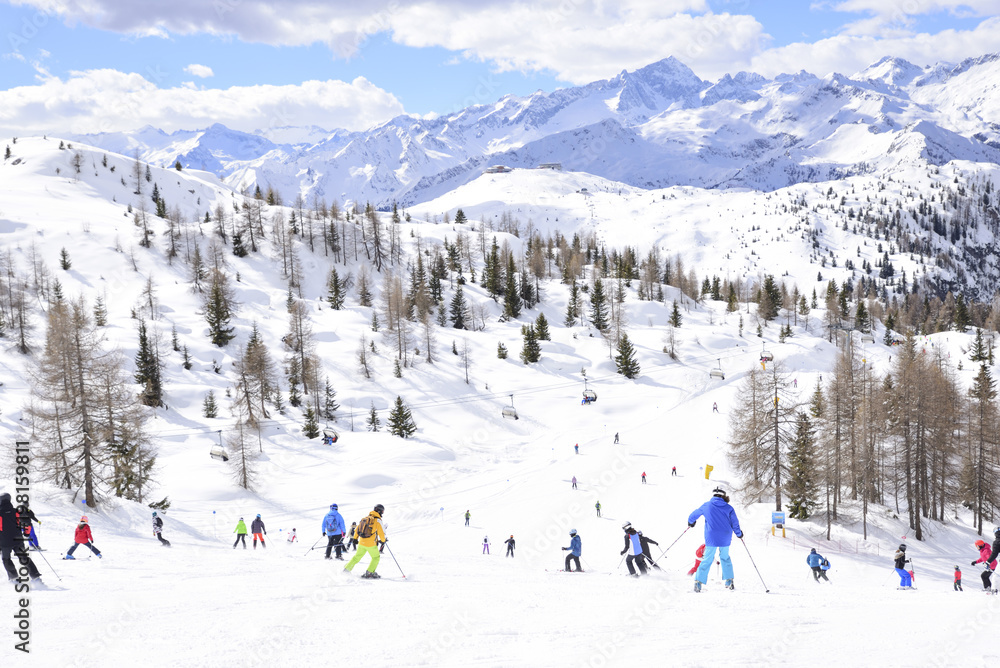 ski slope with skiers in the Alps ski slope with skiers in the Alps