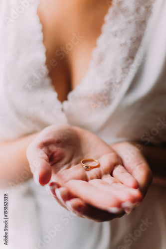 Bride`s hands holding the wedding rign photo