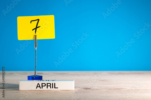 April 7th. Day 7 of april month, calendar on little yellow tag. Spring time. Empty space for text, mockup or template