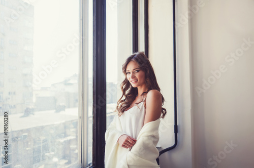 Free Download Portrait woman at home near window. Girl in loft living room - GFXLoad