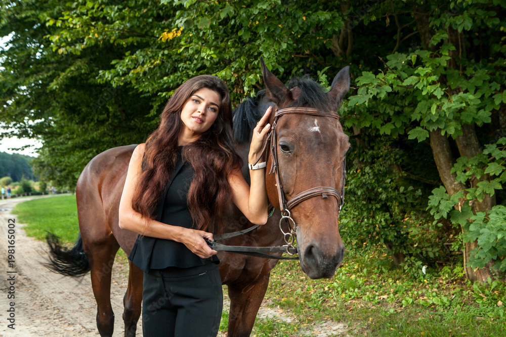 Pretty young woman and a brown horse Pretty young woman and a brown horse