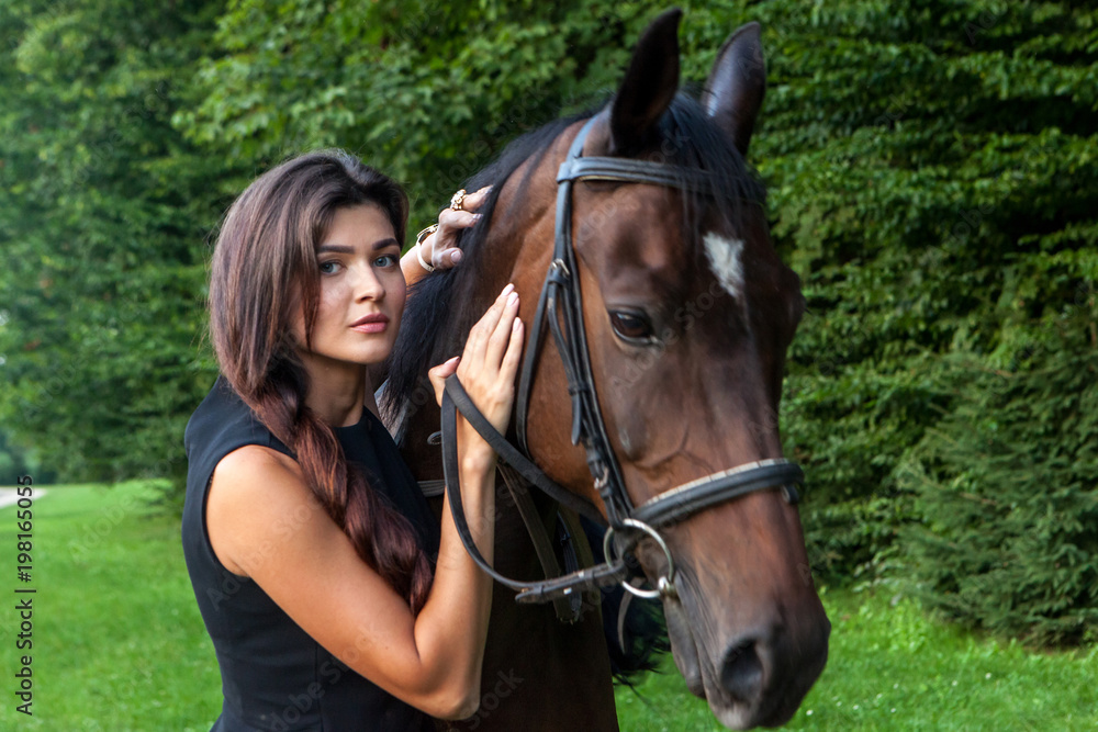 Pretty young woman and a brown horse Pretty young woman and a brown horse