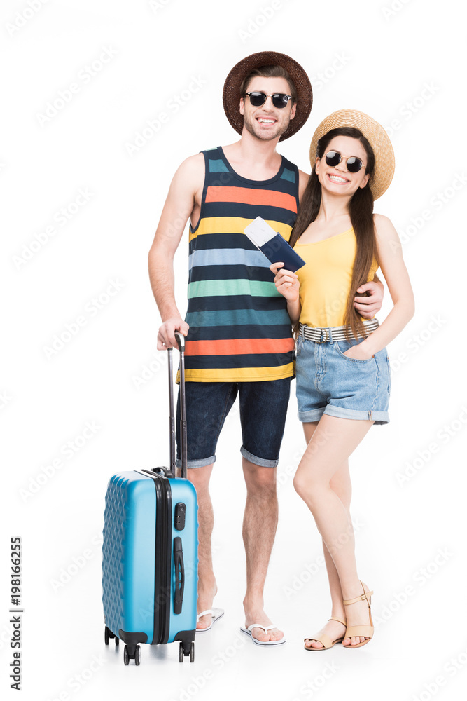 smiling tourists posing with travel bag, isolated on white smiling tourists posing with travel bag, isolated on white
