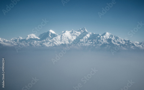 The Himalayas as seen from an airplane in Nepal. Layer of clouds beneath the mountain tops.   © Thomas Dutour