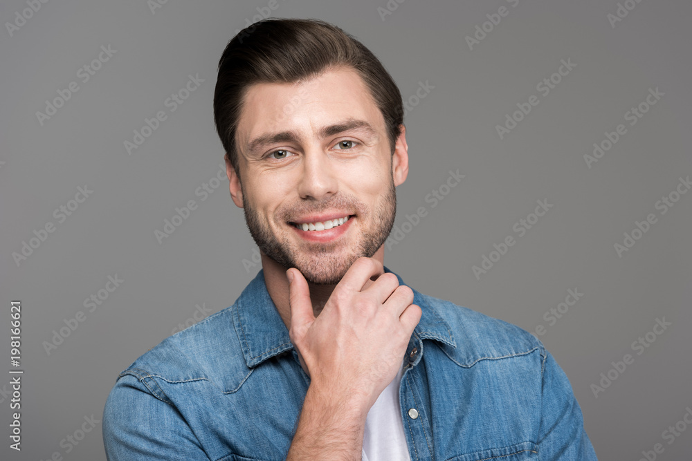 portrait of handsome smiling man, isolated on grey portrait of handsome smiling man, isolated on grey