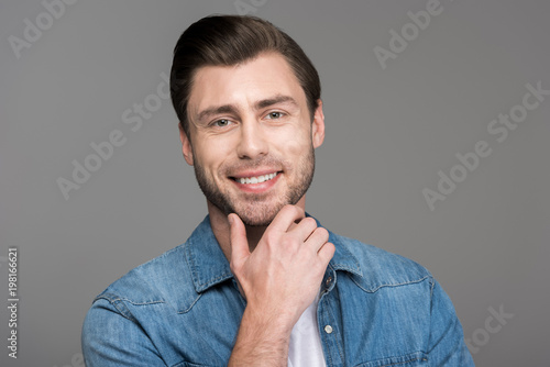 portrait of handsome smiling man, isolated on grey