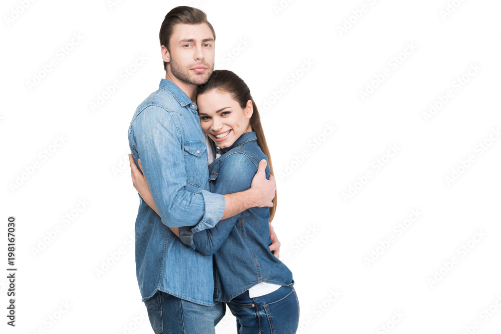cheerful young couple embracing and looking at camera, isolated on white cheerful young couple embracing and looking at camera, isolated on white