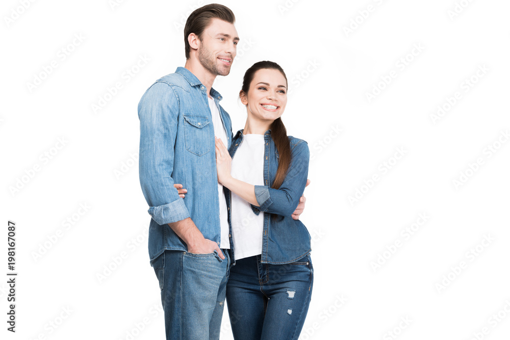 young couple in jeans embracing isolated on white young couple in jeans embracing isolated on white