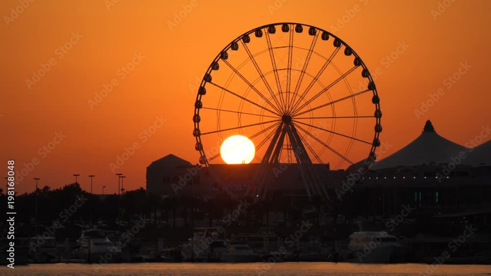 Ferris wheel seen at sunset in Abu Dhabi Ferris wheel seen at sunset in Abu Dhabi