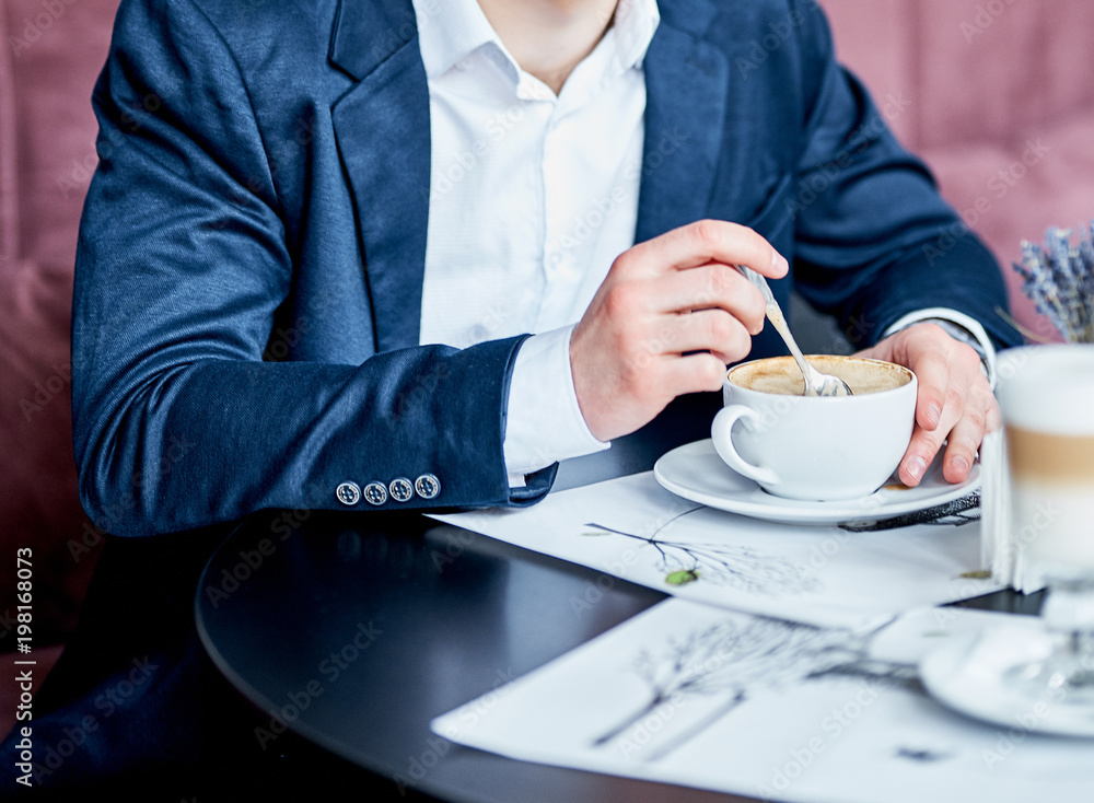 Business man in suit drinking coffee in cafe Business man in suit drinking coffee in cafe
