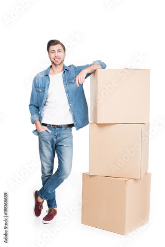 smiling young man with carton boxes, isolated on white