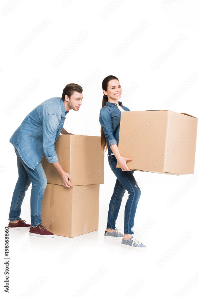 young couple relocating with carton boxes, isolated on white young couple relocating with carton boxes, isolated on white
