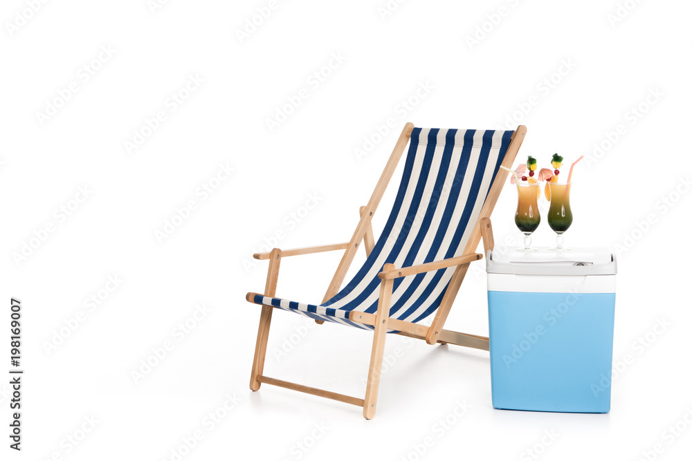 striped beach chair, cooler box and summer cocktails, isolated on white