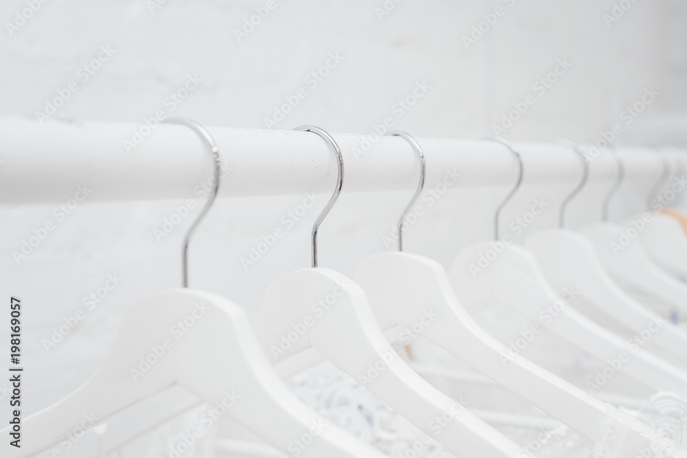 Fototapeta premium Hangers row all white with black hooks