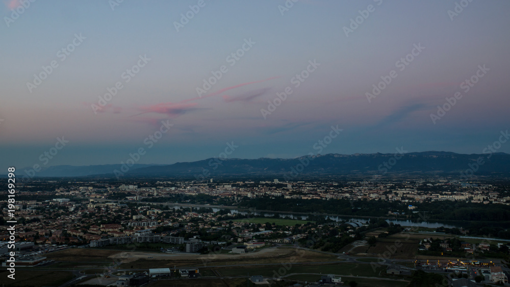Panoramic view on Valence city in Rhone-Alpes French region with mountains on a background during the sunset.
