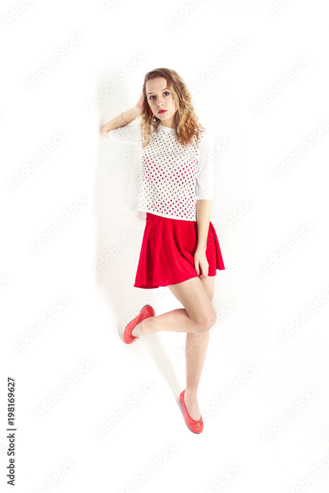 Isolated photo. The young girl with red lips and skirt on the white background Isolated photo. The young girl with red lips and skirt on the white background