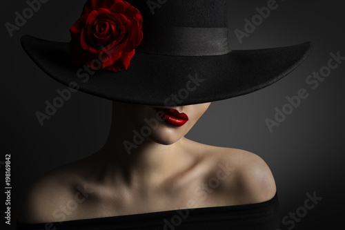 Woman Red Lips and Rose Flower in Hat, Fashion Model Beauty Portrait, Black Retro Wide Brimmed Hat photo