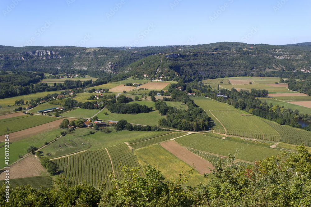 View over patchwork fields and farms in the Lot Valley from Saut de la Mounine viewpoint near Cajarc, Lot, Quercy, France