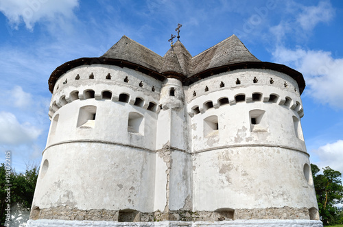 Ancient, defensive church on the background of the blue sky photo